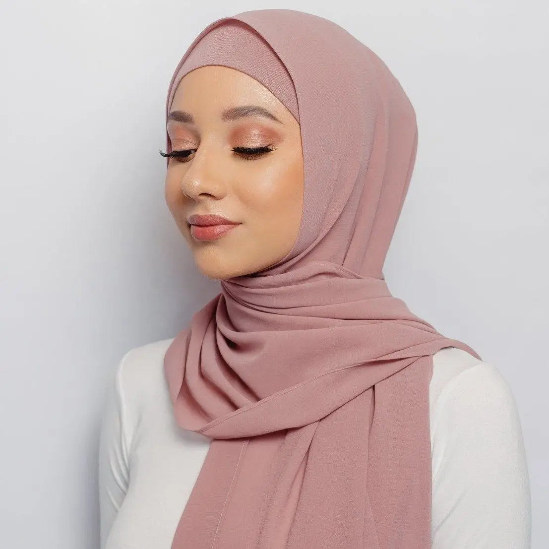 Elegant and versatile, the pearl-embellished silk chiffon hijab is the perfect accessory to elevate your outfit with style and grace.